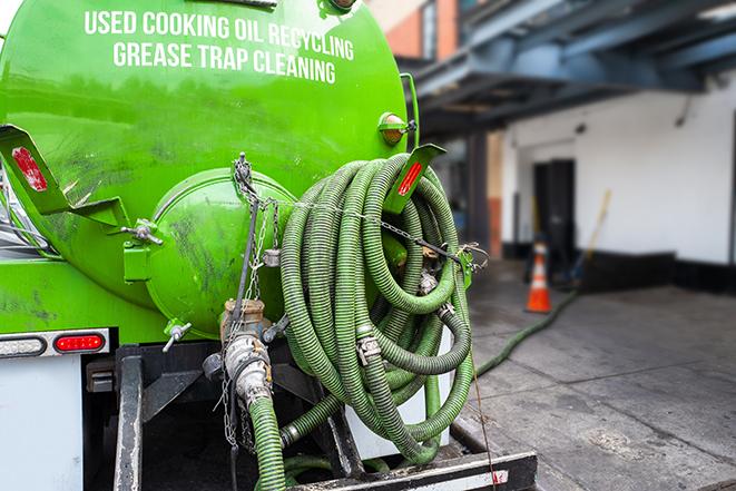 a grease trap being pumped by a sanitation technician in Lyndhurst, OH